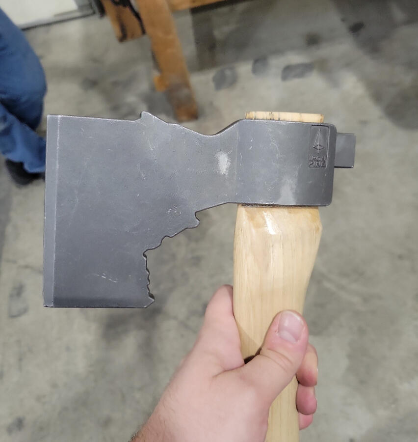 Hand holding axe head proof